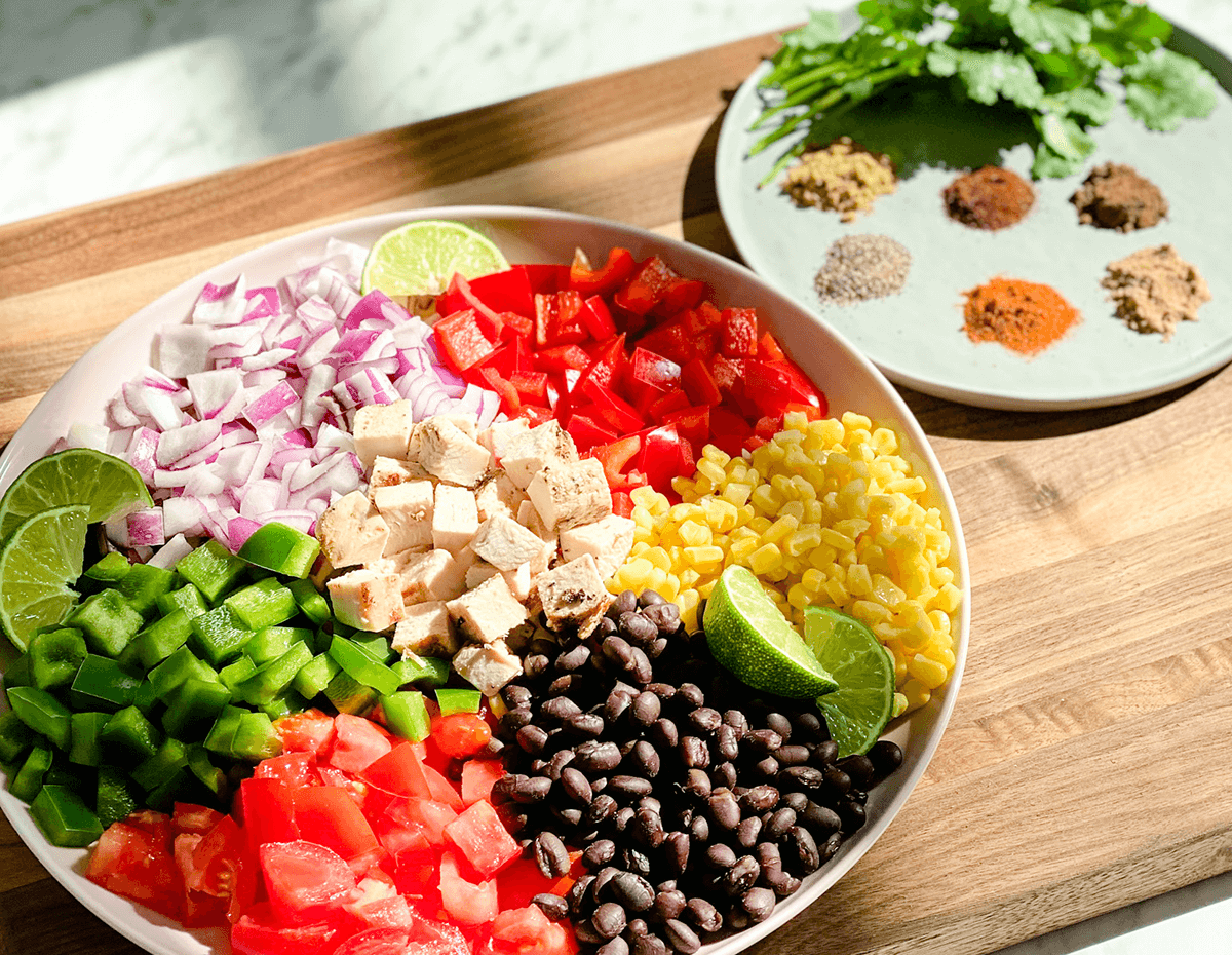 Ingredients in grilled chicken, corn and black bean fiesta salad