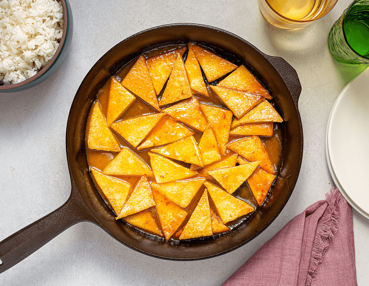 A cast iron pan full of delicious adobo tofu