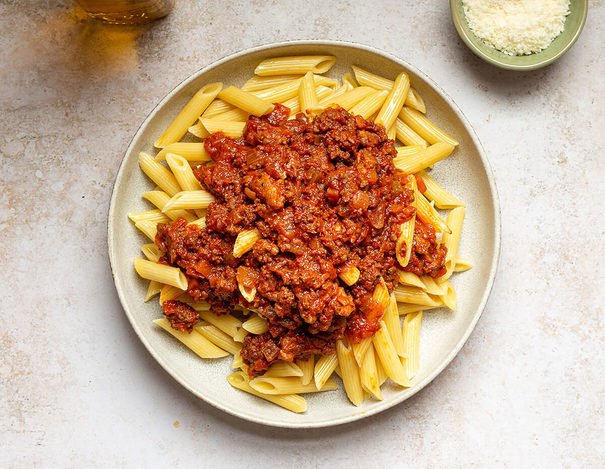 Bolognese sauce served over penne pasta
