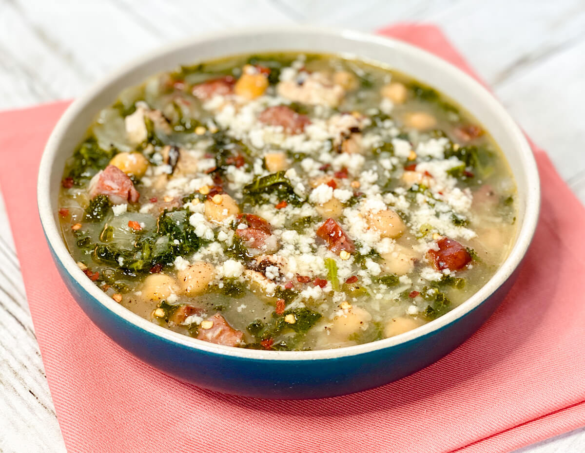 A bowl of chicken caldo verde, Portuguese potato and kale soup