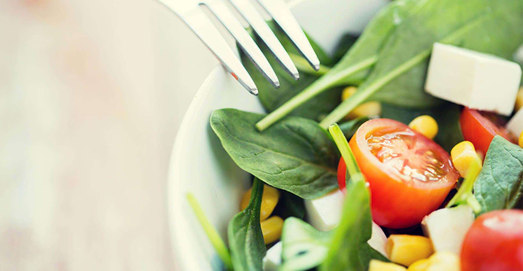 A close up of a fresh spinach salad