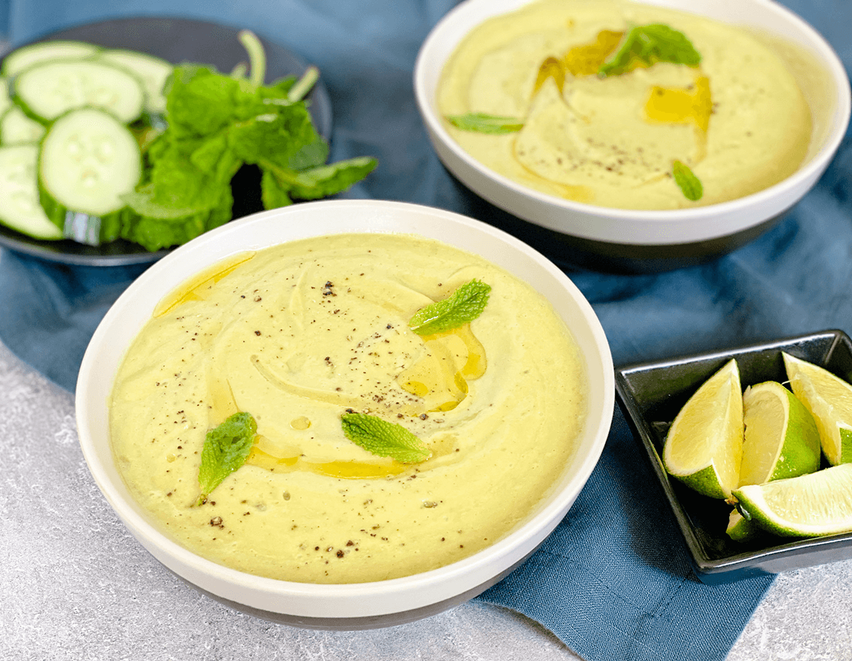 Two bowls of cool avocado and cucumber soup