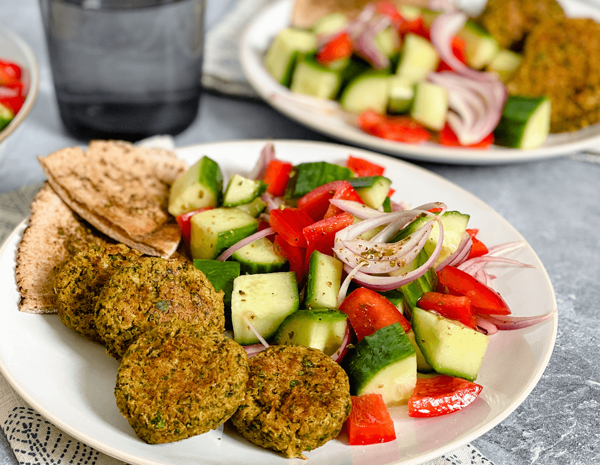 A plate of falafel with a cucumber salad