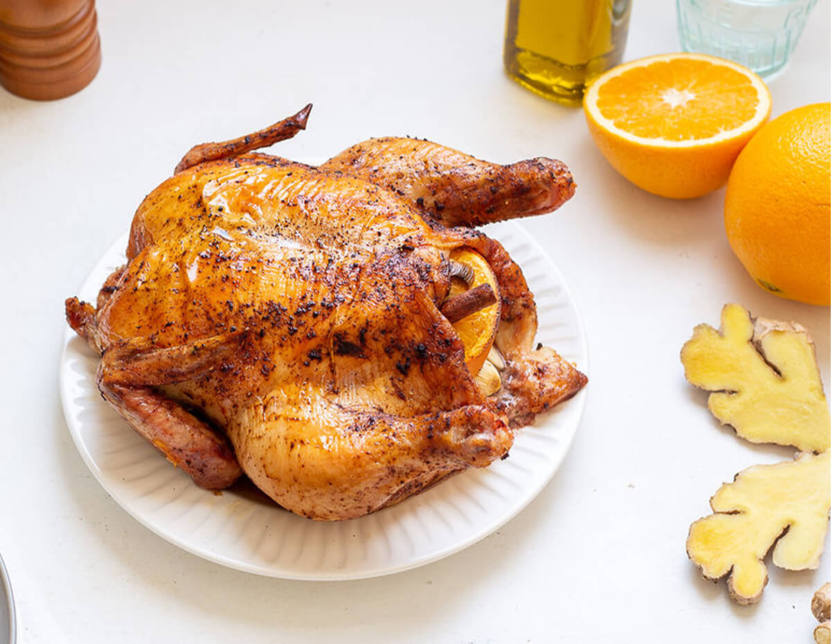 Whole roasted ginger orange chicken served on a plate