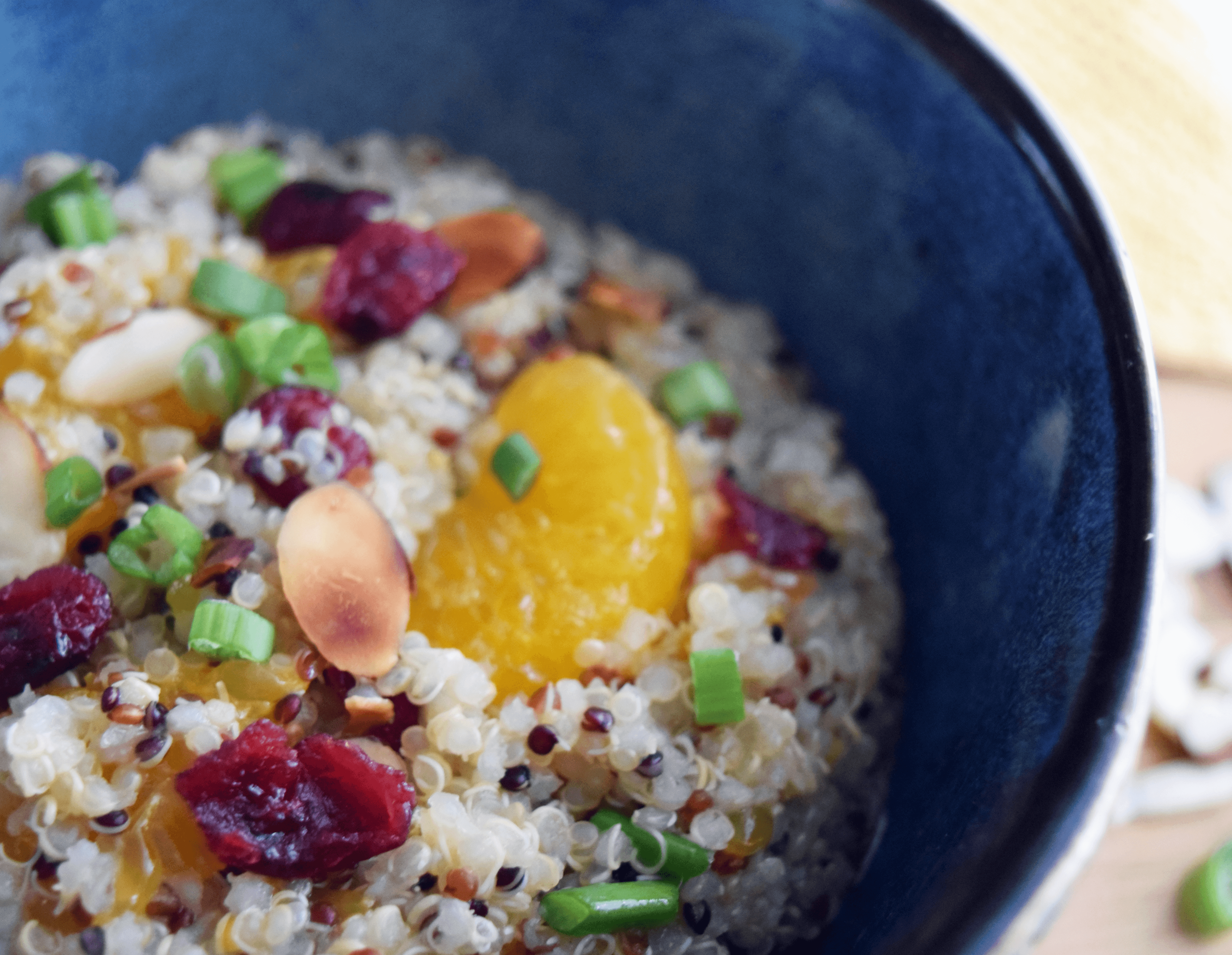 A closeup of a bowl of orange quinoa salad