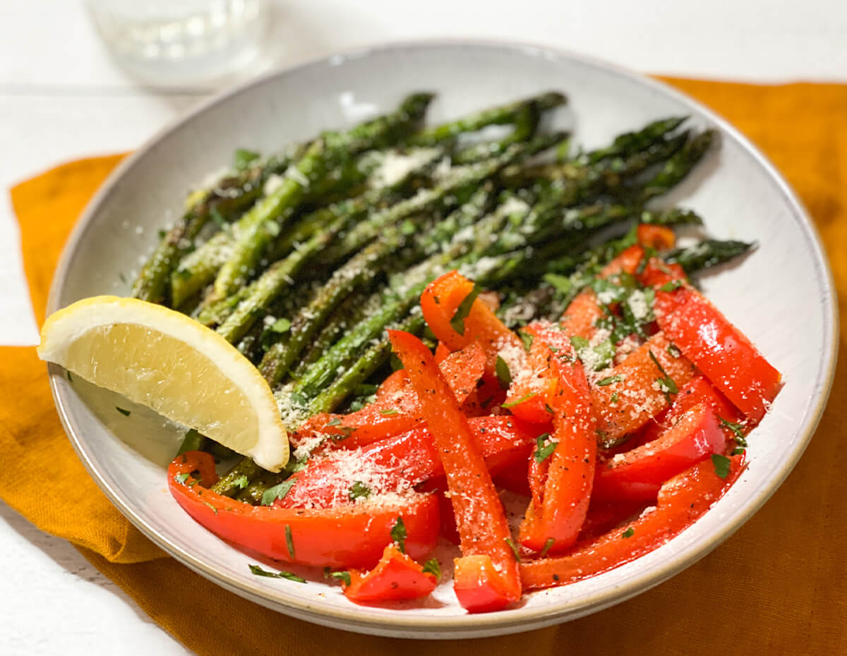 A plate of roasted asparagus and red peppers