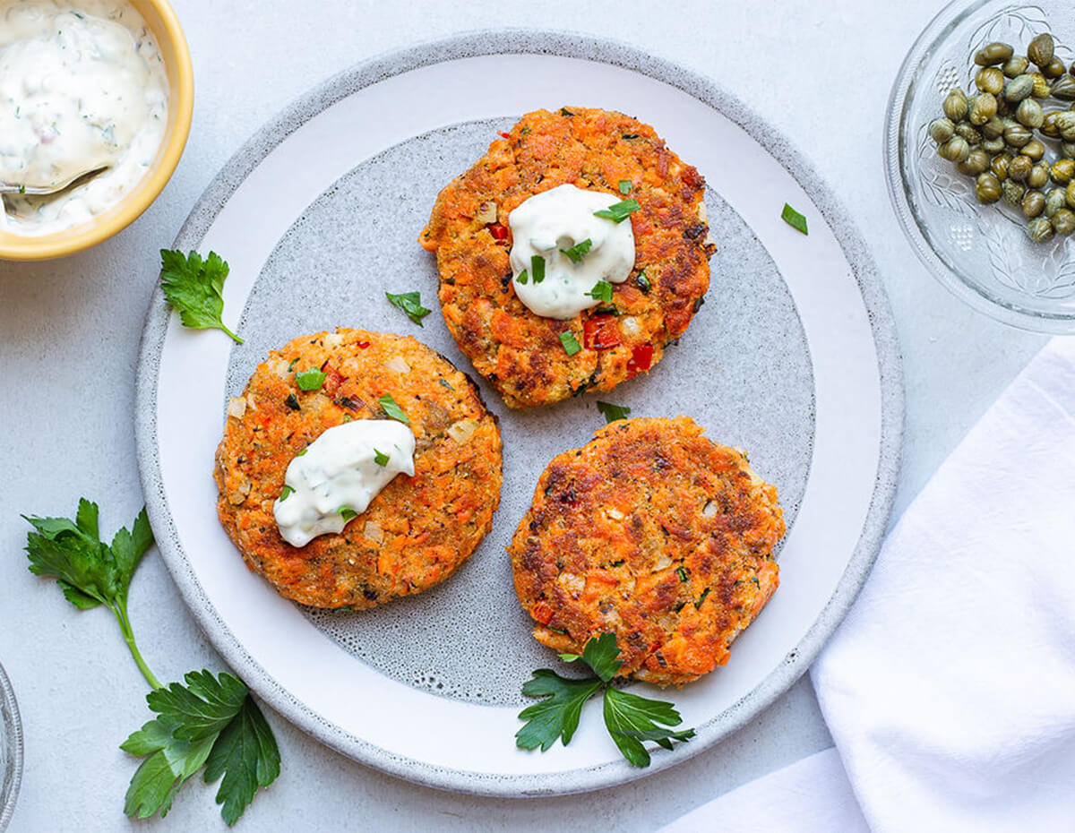 Three delicious salmon cakes with some remoulade
