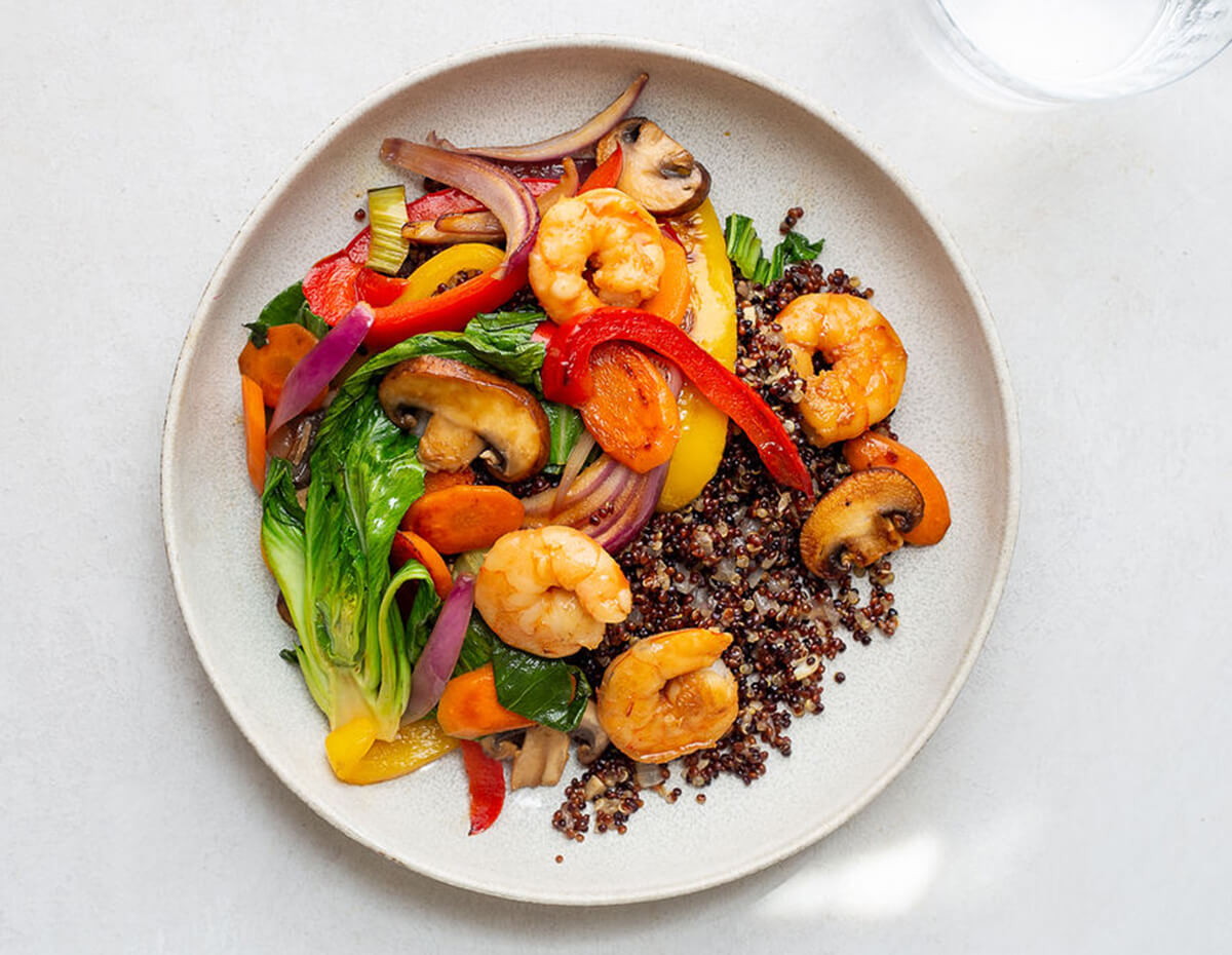 Shrimp Stir-fry with veggies and quinoa platted