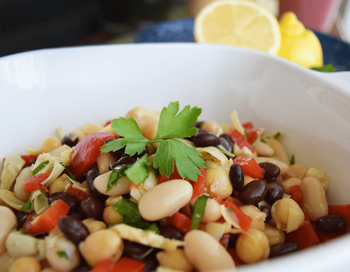A closeup of a bowl of Sicilian bean and red pepper salad
