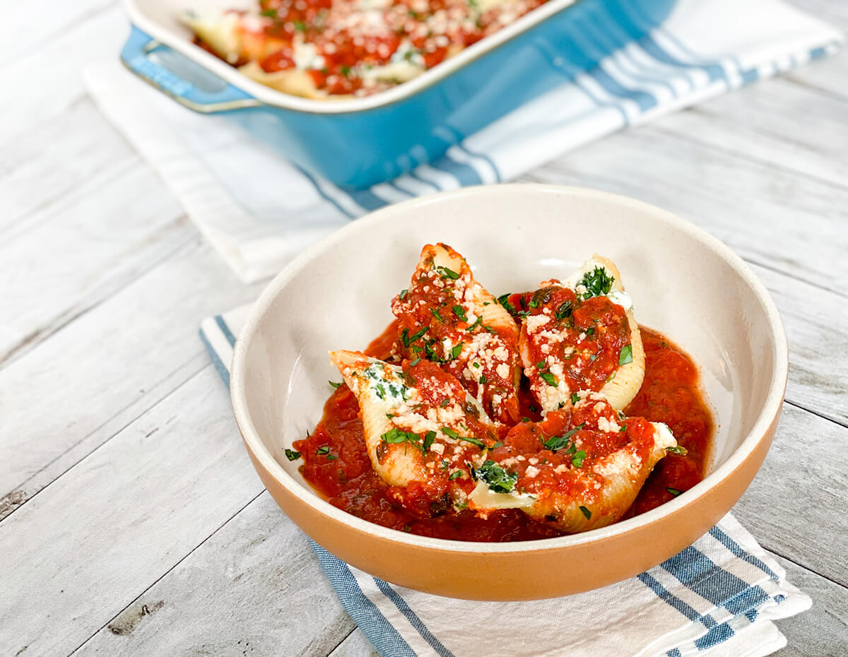 A bowl containing a hearty helping of stuffed shells