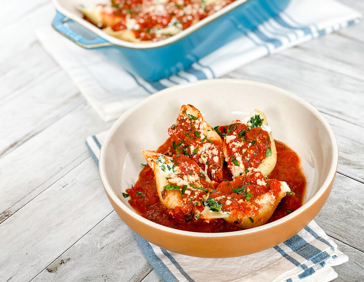 A bowl containing a hearty helping of stuffed shells